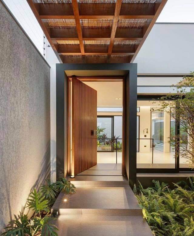 Unique Inviting Entrance Paired With A Wooden Door